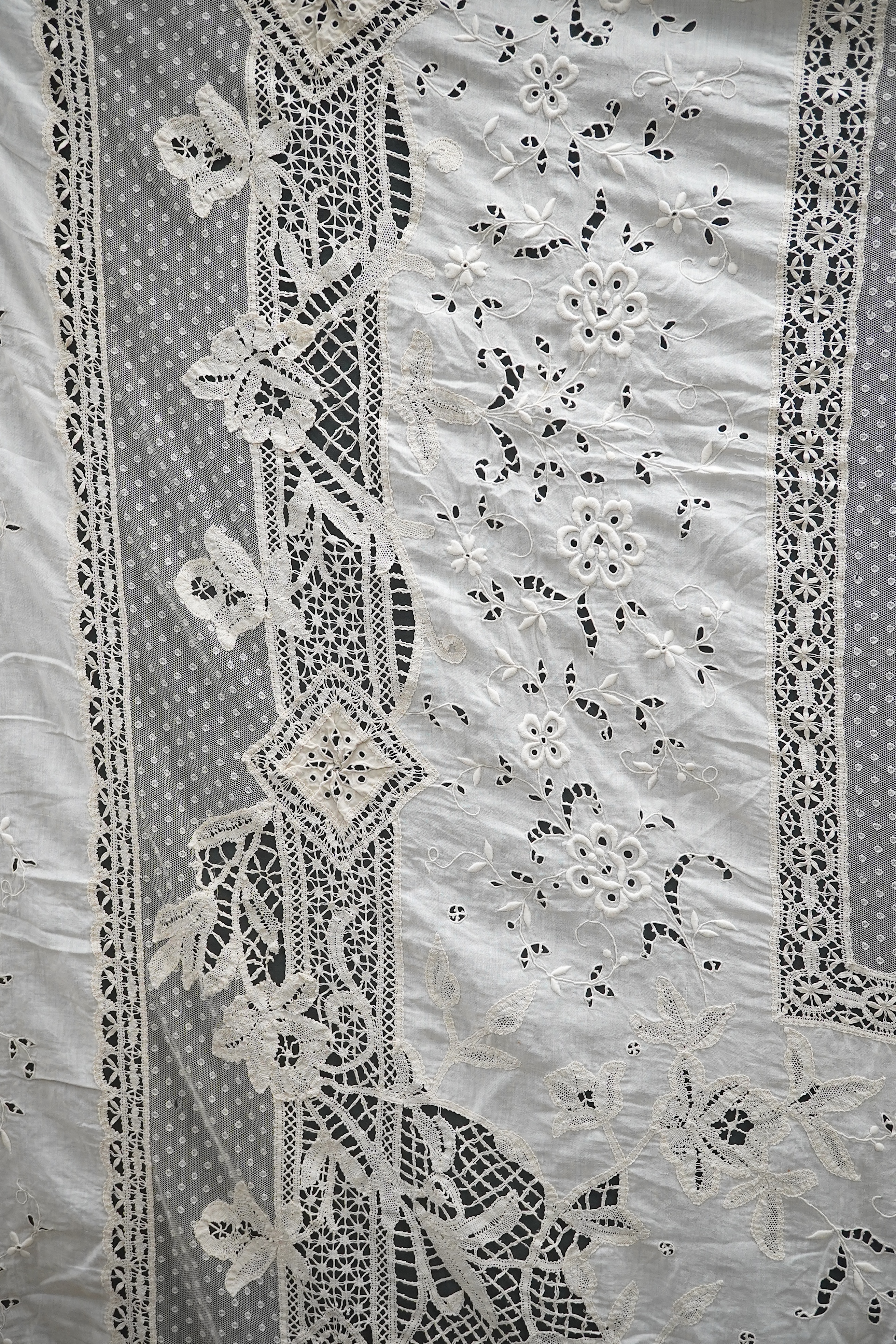 An ornate Edwardian bed cover, handmade from cut work anglaise panels, fine spot motif net and bobbin lace insertions, 228cm wide x 228 cm long. Condition - the spot motif net and fine lawn are damaged in places, the law